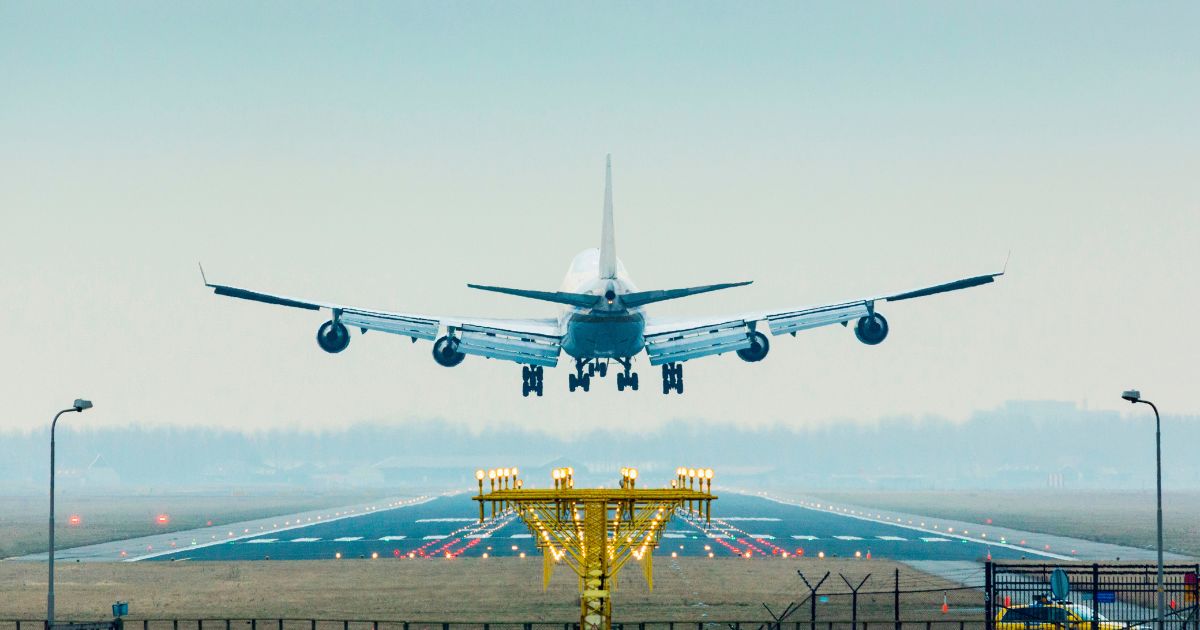 This stock image shows a plane landing at an airport. Reports indicate that thousands of people are flying into South and Central America in hopes of migrating north and crossing the U.S. border.