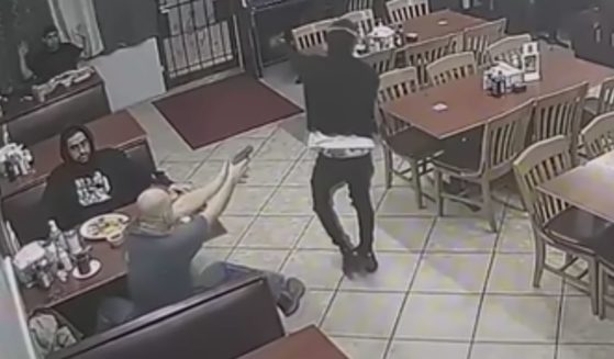 After the robber went past his table, a customer pulled out a weapon and shot him several times.