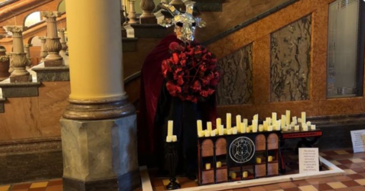 Michael Cassidy is being charged with a hate crime for destroying the pictured Satanic Temple display that was located in the Iowa Capitol.