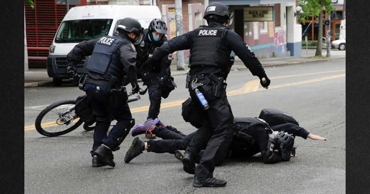 Seattle Police tackle a demonstrator who was blocking the intersection of East Pine Street and 11th Avenue after police cleared the Capitol Hill Occupied Protest and retook the department's East Precinct in Seattle, Washington on July 1, 2020.