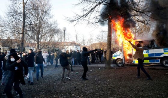 Police vans are on fire as protesters react in the park Sveaparken in Orebro, Sweden, on April 15, 2022.
