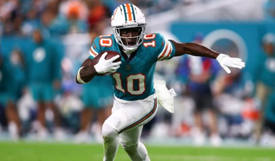 Tyreek Hill of the Miami Dolphins carries the ball against the Dallas Cowboys during the fourth quarter of a game at Hard Rock Stadium on Dec. 24, 2023, in Miami Gardens, Florida.