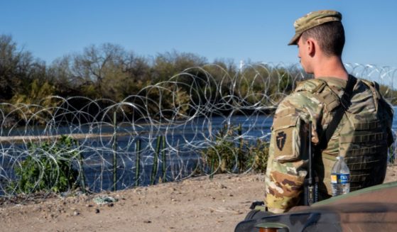 A National Guard soldier stands guard on the banks of the Rio Grande on Jan. 12 in Eagle Pass, Texas.
