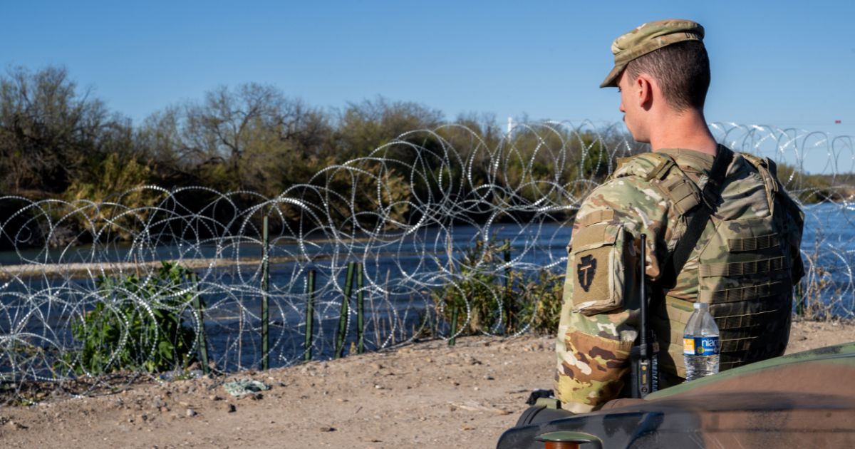A National Guard soldier stands guard on the banks of the Rio Grande on Jan. 12 in Eagle Pass, Texas.