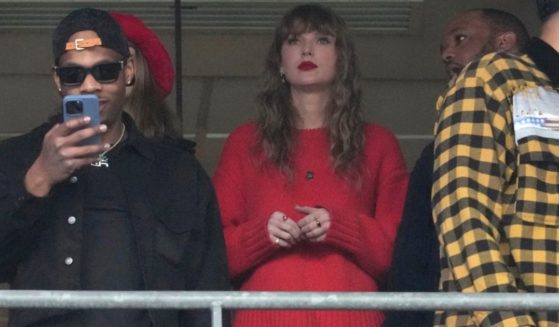 Taylor Swift, center, watches the AFC Championship NFL football game between the Baltimore Ravens and the Kansas City Chiefs, Sunday, in Baltimore.