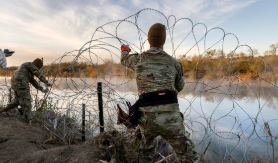 Texas National Guard soldiers install additional razor wire along the Rio Grande in Eagle Pass, Texas, on Jan. 10.
