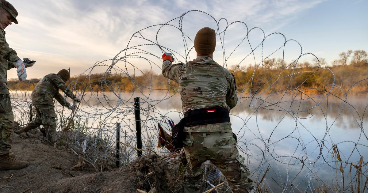 Texas National Guard soldiers install additional razor wire along the Rio Grande in Eagle Pass, Texas, on Jan. 10.