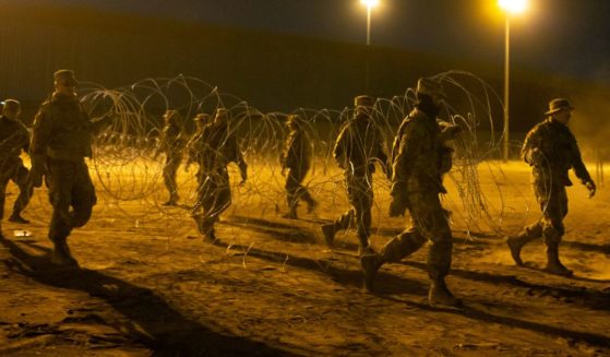Texas National Guard soldiers carrying concertina wire