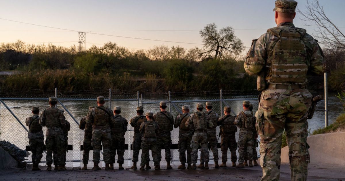 National Guard soldiers stand guard on the banks of the Rio Grande on Jan. 12 in Eagle Pass, Texas.