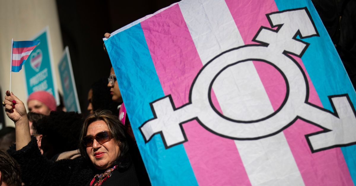 Activists rally in support of transgender people on the steps of New York City Hall.
