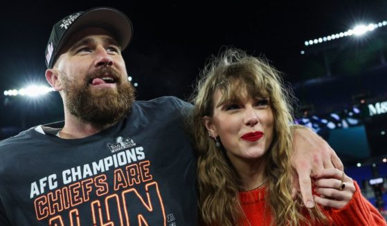 Travis Kelce, left, and Taylor Swift, right, celebrate after the Kansas City Chiefs defeat the Baltimore Ravens in Baltimore on Sunday to become the AFC Champions.