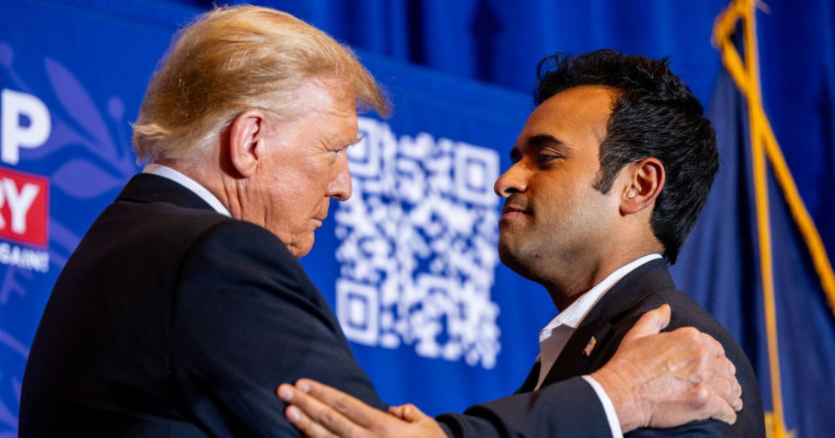 Former President Donald Trump, left, and former Republican presidential hopeful Vivek Ramaswamy, right, embrace during a Trump campaign rally in Atkinson, New Hampshire, on Tuesday. Ramaswamy dropped out of the Republican primary on Monday night and endorsed Trump's campaign.