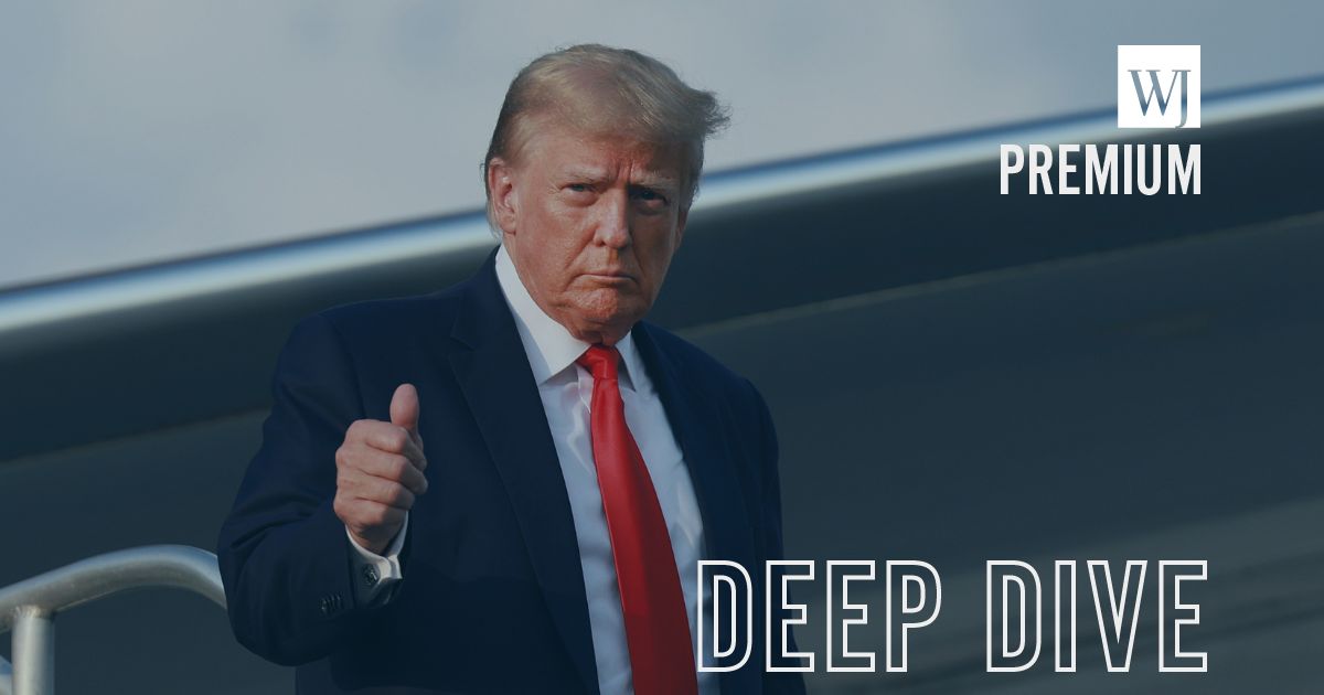 Former President Donald Trump gives a thumbs up while leaving his plane.