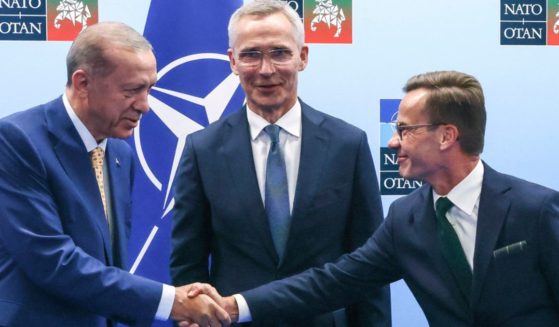 Turkey's President Recep Tayyip Erdogan, left, shakes hands with Sweden's Prime Minister Ulf Kristersson, right, as NATO Secretary General Jens Stoltenberg looks on prior to a meeting ahead of a NATO summit in Vilnius, Lithuania, on July 10.