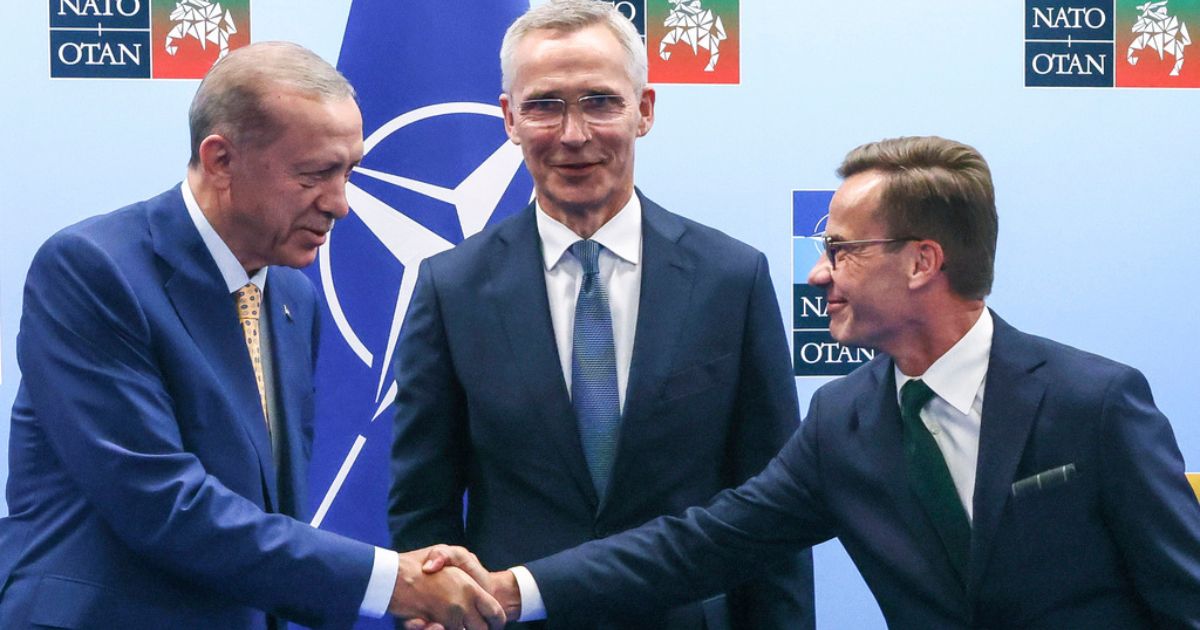 Turkey's President Recep Tayyip Erdogan, left, shakes hands with Sweden's Prime Minister Ulf Kristersson, right, as NATO Secretary General Jens Stoltenberg looks on prior to a meeting ahead of a NATO summit in Vilnius, Lithuania, on July 10.