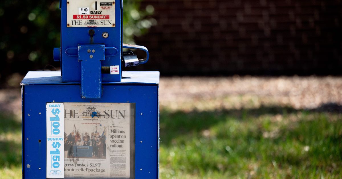 A Baltimore Sun newspaper bin stands in the Maryland city in 2021. Conservative media mogul David Smith is the new owner of the outlet.