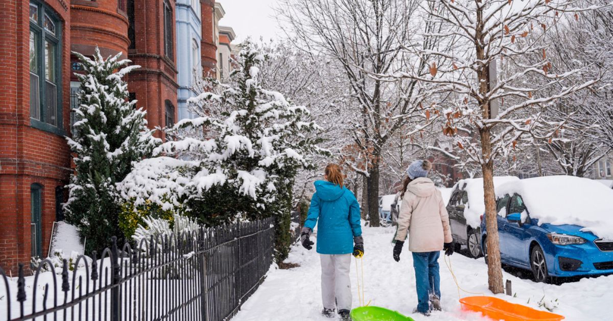 Girls walk through the snowy Capitol Hill neighborhood in Washington D.C. Friday.