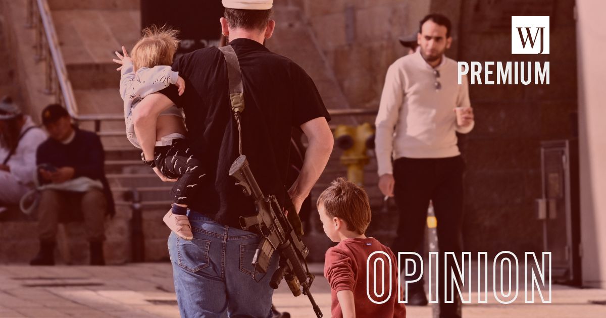 A Jewish man, carrying a gun, walks with children in Jerusalem's Old City, on Jan. 1. Since the Oct. 7 Hamas terror attacks, Israel has relaxed its gun laws to enable citizens to protect themselves.
