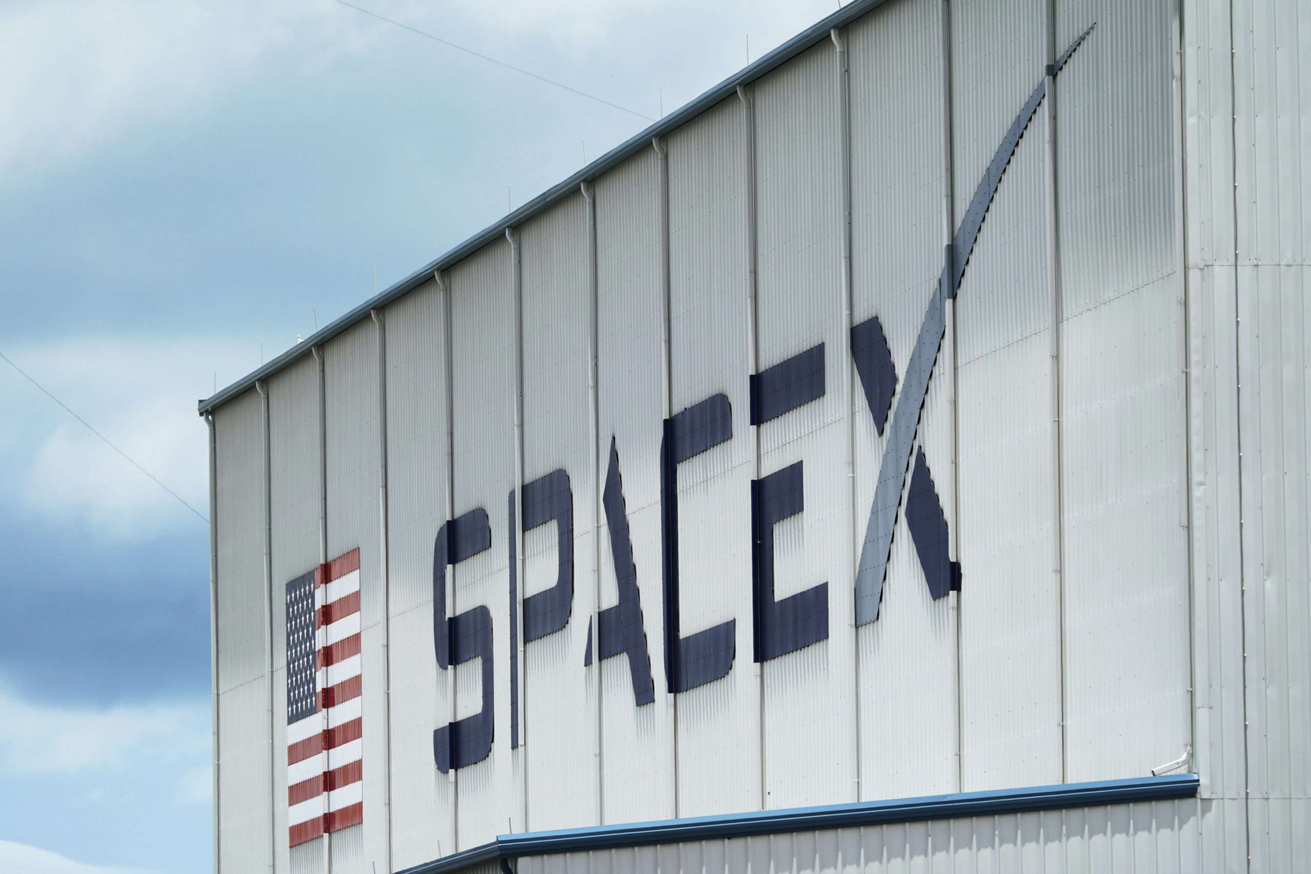 The SpaceX logo is displayed on a building at the Kennedy Space Center in Cape Canaveral, Florida, on May 26, 2020.