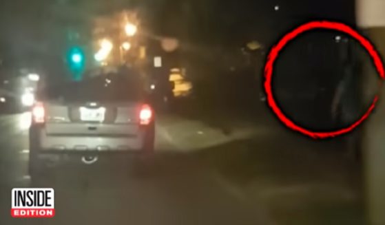A video captures an incident where Louisville police detectives pelted pedestrians with cold drinks from their unmarked vehicle.