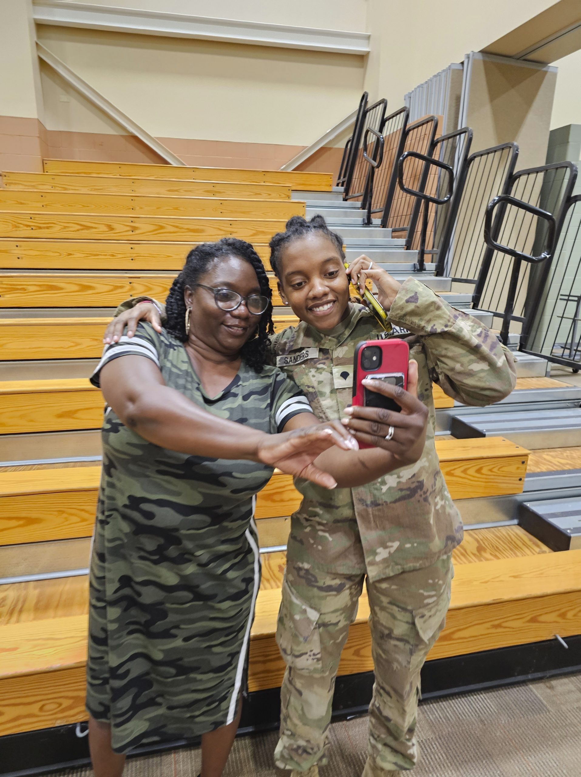 Army Spc. Kennedy Sanders, right, poses for a photo with her mother, Oneida Oliver-Sanders, at a ceremony in Columbus, Georgia, on Aug. 9.