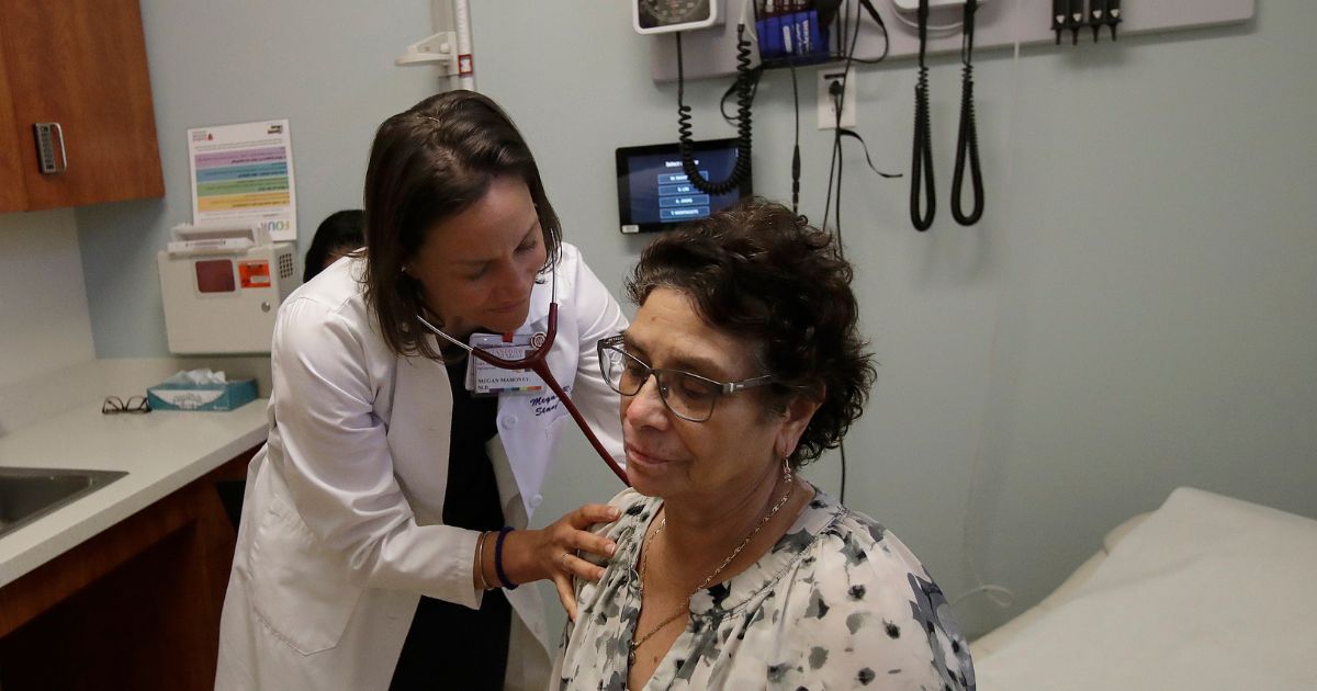 a doctor examining a patient in her office