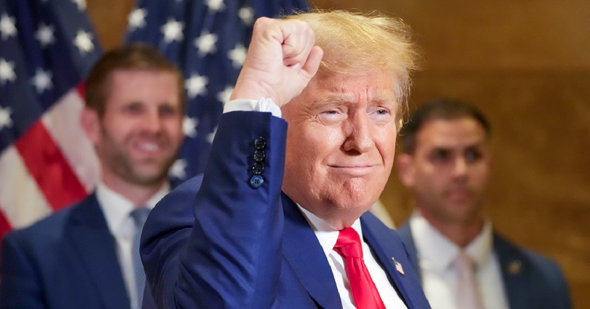 Former President Donald Trump grins and pumps a fist Thursday in New York for supporters who turned out to see him as his trial on civil fraud charges in Manhattan wound down.