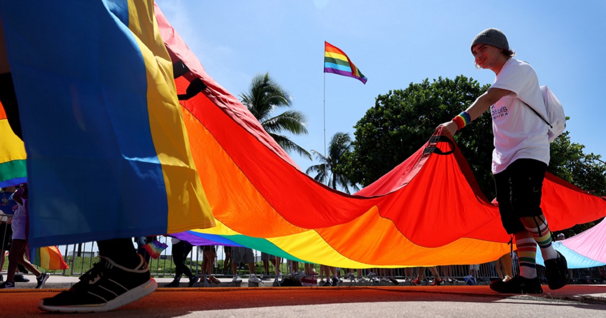 Marchers carry a rainbow flag in Miami Beach in September 2021 as part of a gay pride demonstration.