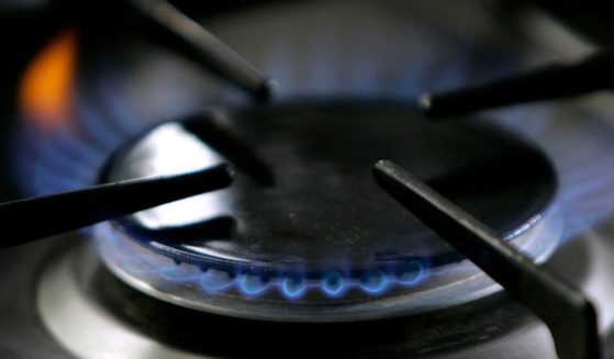 a gas-lit flame burning on a natural gas stove