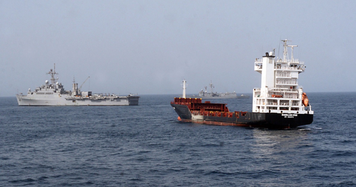 In a September 2010 file photo, a U.S. Navy ship conducts a raid in the Gulf of Aden a on a commercial vessel, right, that had been seized by pirates.