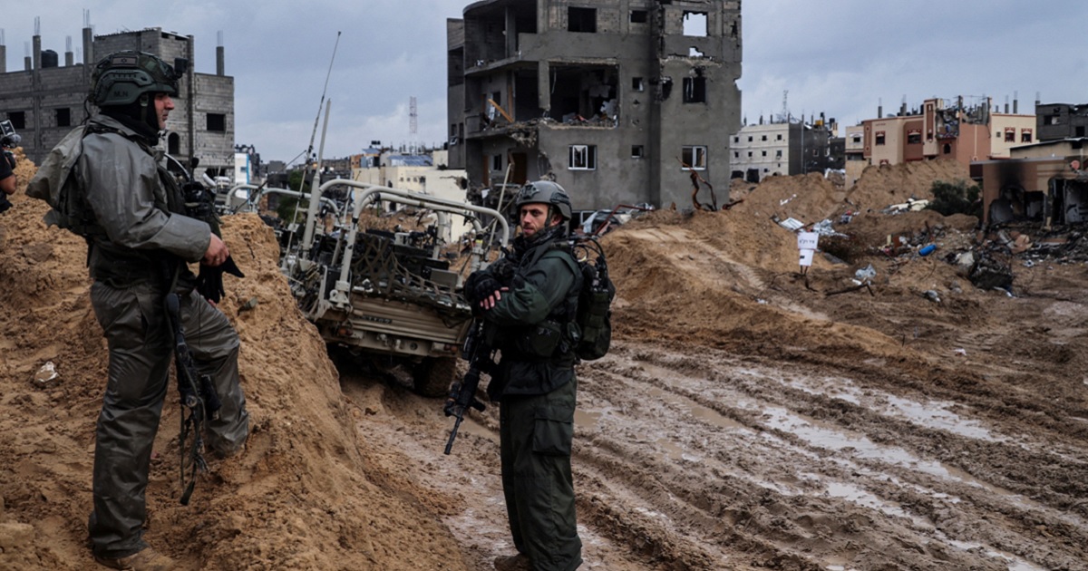Israeli soldiers are pictured patrolling an area of the southern Gaza city of Khan Yunis in a photo taken during a media tour controlled by the Israeli military. The photo was edited under Israeli military supervision.