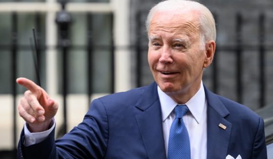 President Joe Biden flashes a grin in a file photo from a trip to London in July.