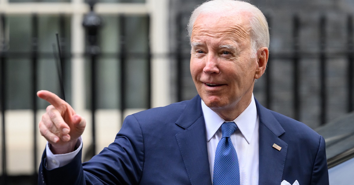 President Joe Biden flashes a grin in a file photo from a trip to London in July.