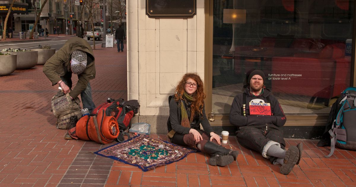Several homeless people sit in front of Macy's on February 11, 2012 in Portland, Oregon.