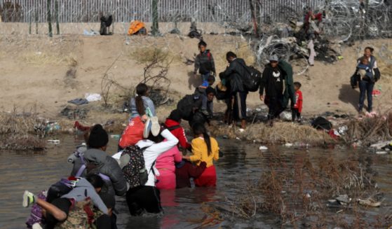 Migrants cross the Rio Grande into the United States from Juarez, Mexico, on Tuesday.