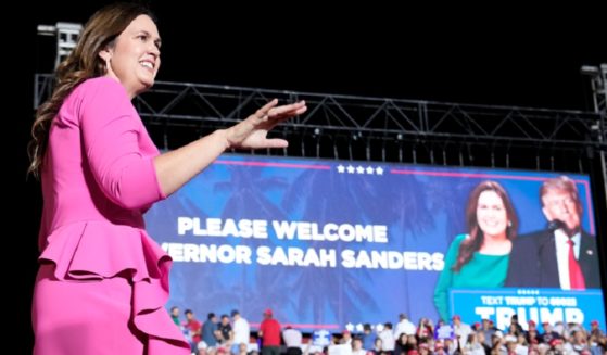 Arkansas Gov. Sarah Huckabee Sanders, walks across a stage after being introduced at a November campaign rally for former President Donald Trump in Hialeah, Florida.