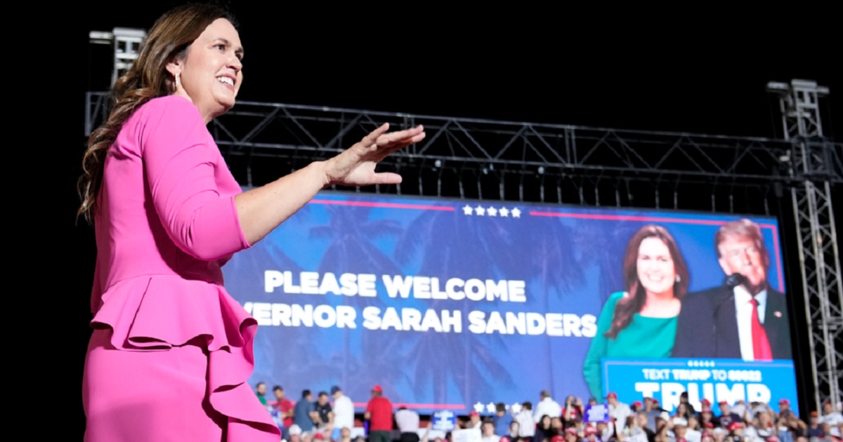 Arkansas Gov. Sarah Huckabee Sanders, walks across a stage after being introduced at a November campaign rally for former President Donald Trump in Hialeah, Florida.