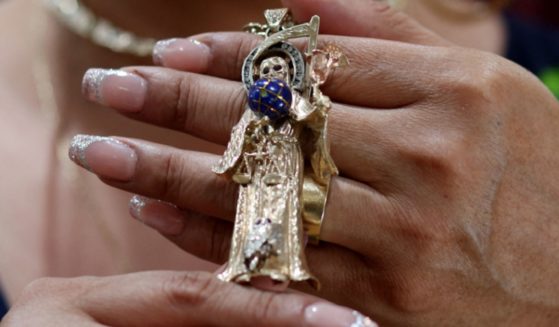 A woman holds a "Santa Muerte" statueette in a file photo in New York City in August.