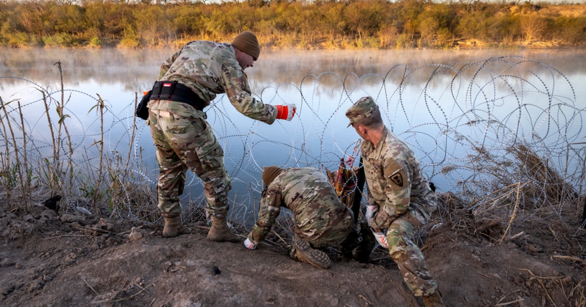 Texas National Guard soldiers install razor wire along the Rio Grande in a Jan. 10 photo.