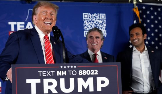 Former President Donald Trump speaks as former Republican presidential contenders North Dakota Gov. Doug Burgum, center, and Vivek Ramaswamy, right, appear on stage Monday during a campaign event in Laconia, New Hampshire.