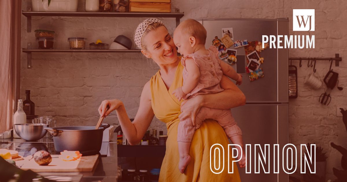 A woman holds a baby while cooking in the above stock image.