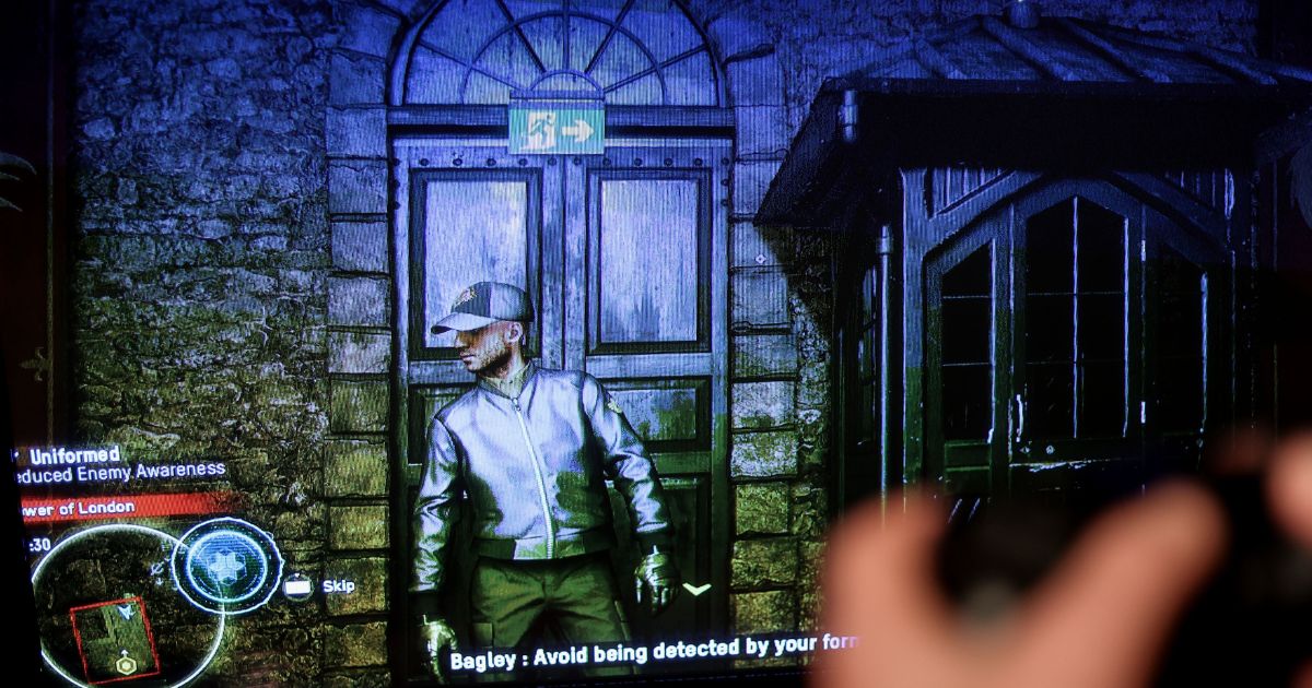 This picture taken on October 28, 2020, in Brussels, shows a screen displaying the new Ubisoft video game "Watch Dogs Legion". The game released on Octoer 28, 2020, by French studio Ubisoft is set in a dystopian near-future London, haunted by authoritarian surveillance and the ghost of Brexit.