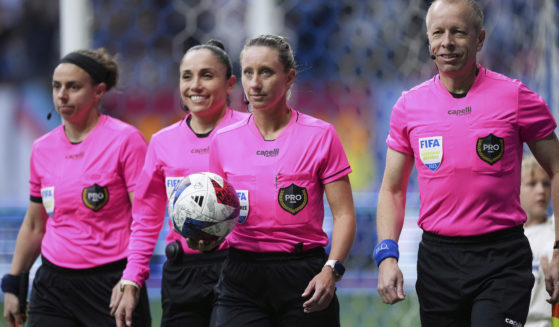 Referee Tori Penso, second from right; fourth official Felisha Mariscal, second from left; and assistant referees Brooke Mayo, left, and Corey Rockwell, right, walk onto the field before the Vancouver Whitecaps and Colorado Rapids played in an MLS soccer match April 29, 2023, in Vancouver, British Columbia. Major League Soccer will lock out referees after its union rejected a tentative contract, putting Lionel Messi’s Inter Miami on track to open the season with replacement officials.
