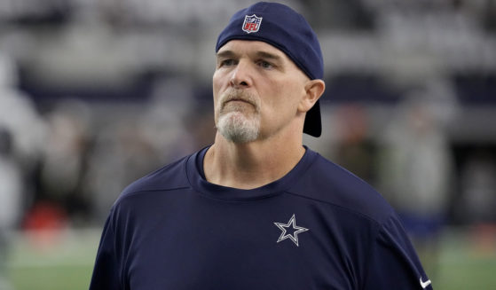 Dallas Cowboys defensive coordinator Dan Quinn watches players warm up for an NFL football game against the Washington Commanders in Arlington, Texas, on Nov. 23.