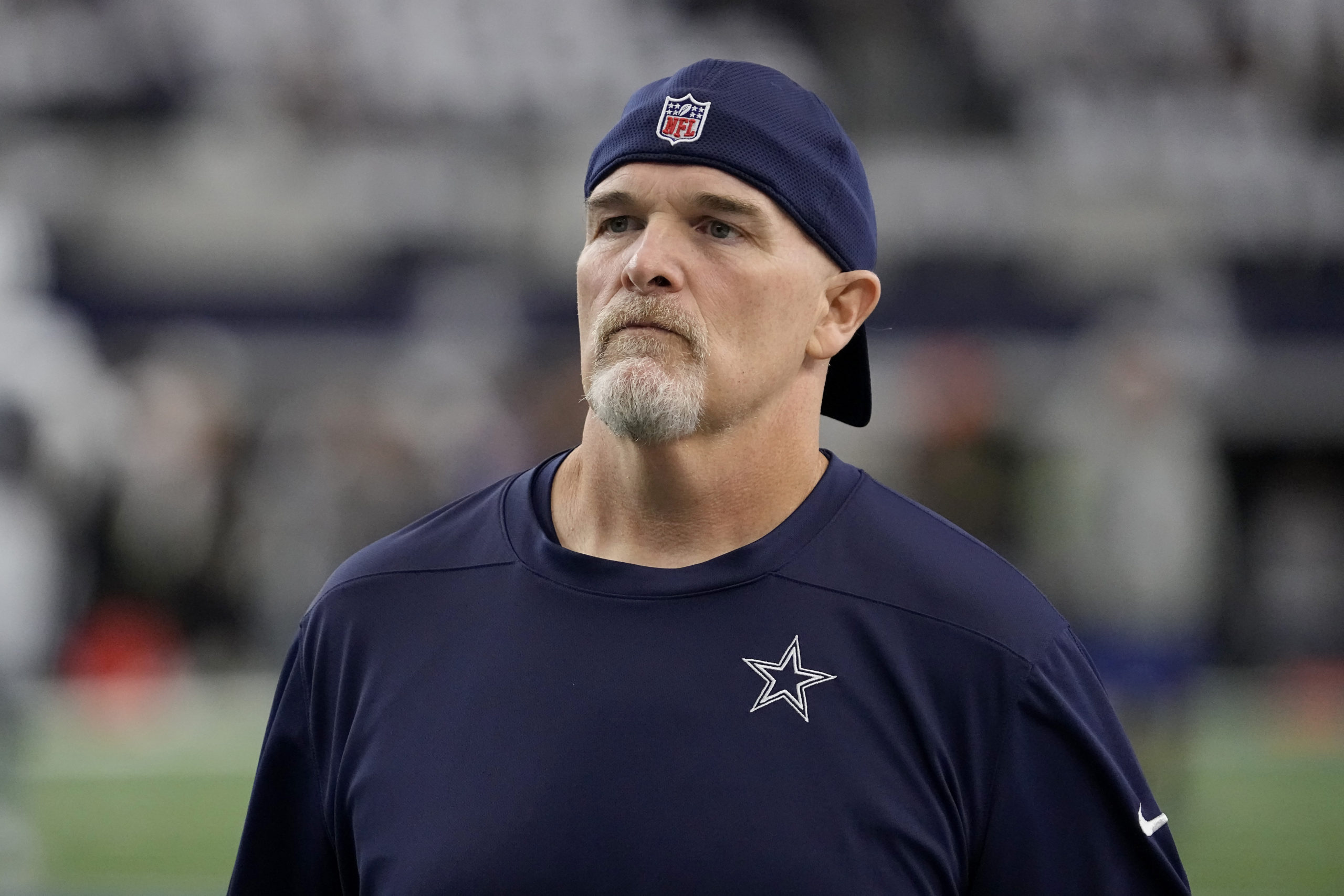 Dallas Cowboys defensive coordinator Dan Quinn watches players warm up for an NFL football game against the Washington Commanders in Arlington, Texas, on Nov. 23.