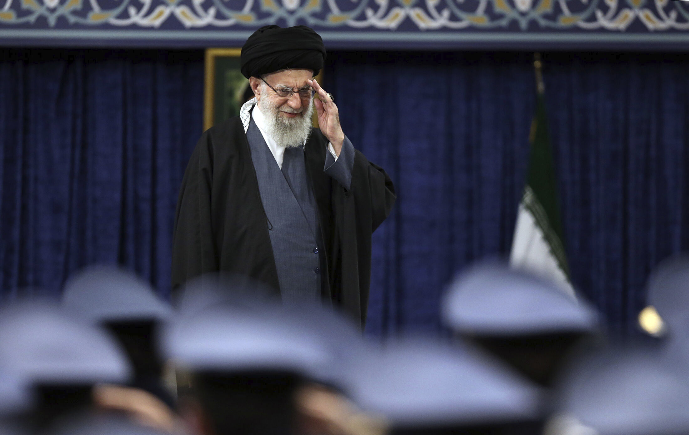 Iranian Supreme Leader Ayatollah Ali Khamenei salutes during a meeting with military staff in Tehran on Monday.