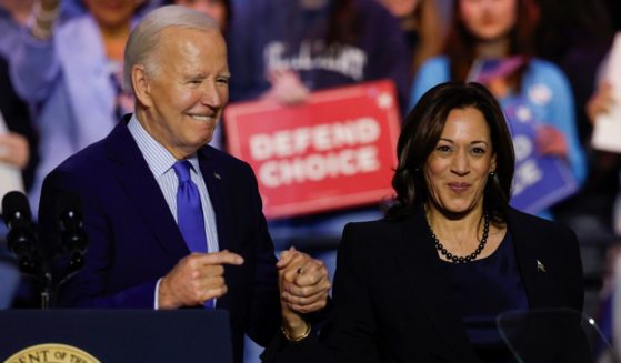 President Joe Biden, left, and Vice President Kamala Harris, right, stand onstage and wave to the crowd at a ”Reproductive Freedom Campaign Rally" in Manassas, Virginia, on Jan. 23.