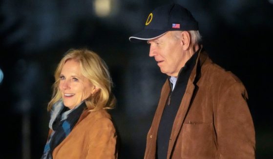 President Joe Biden and first lady Jill Biden walk across the South Lawn of the White House in Washington late Sunday after returning from a trip to Delaware.