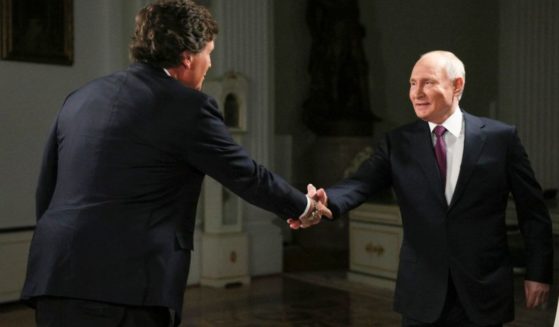Former Fox News host Tucker Carlson, left, shakes hands with Russian President Vladimir Putin, at the Kremlin in Moscow, Russia, Tuesday.