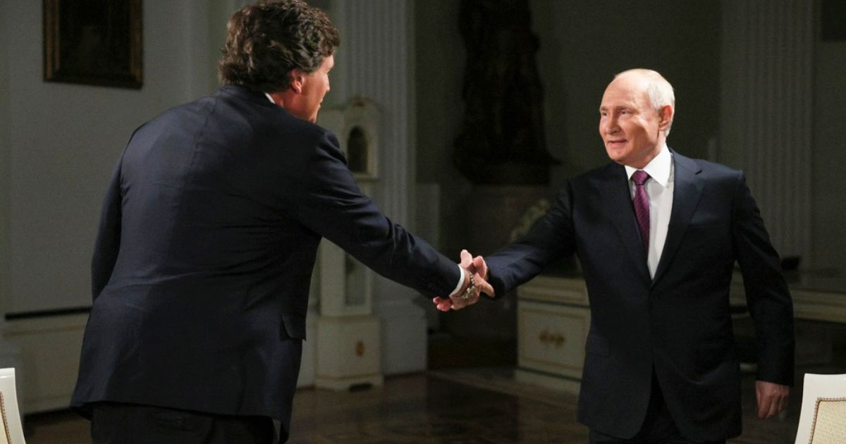 Former Fox News host Tucker Carlson, left, shakes hands with Russian President Vladimir Putin, at the Kremlin in Moscow, Russia, Tuesday.